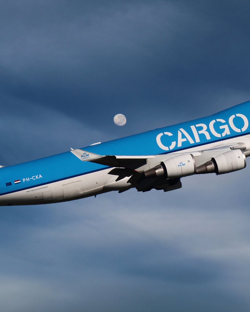 Wide-body cargo aircraft climbing after departure