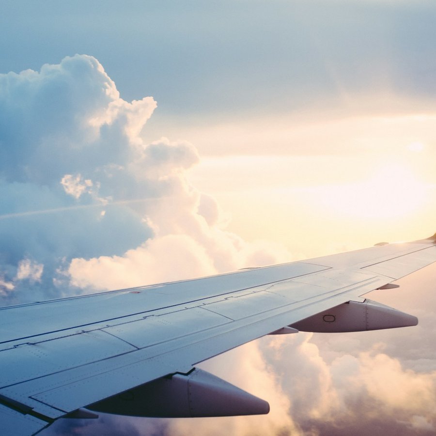 Aircraft wing above cloud on an international freight route