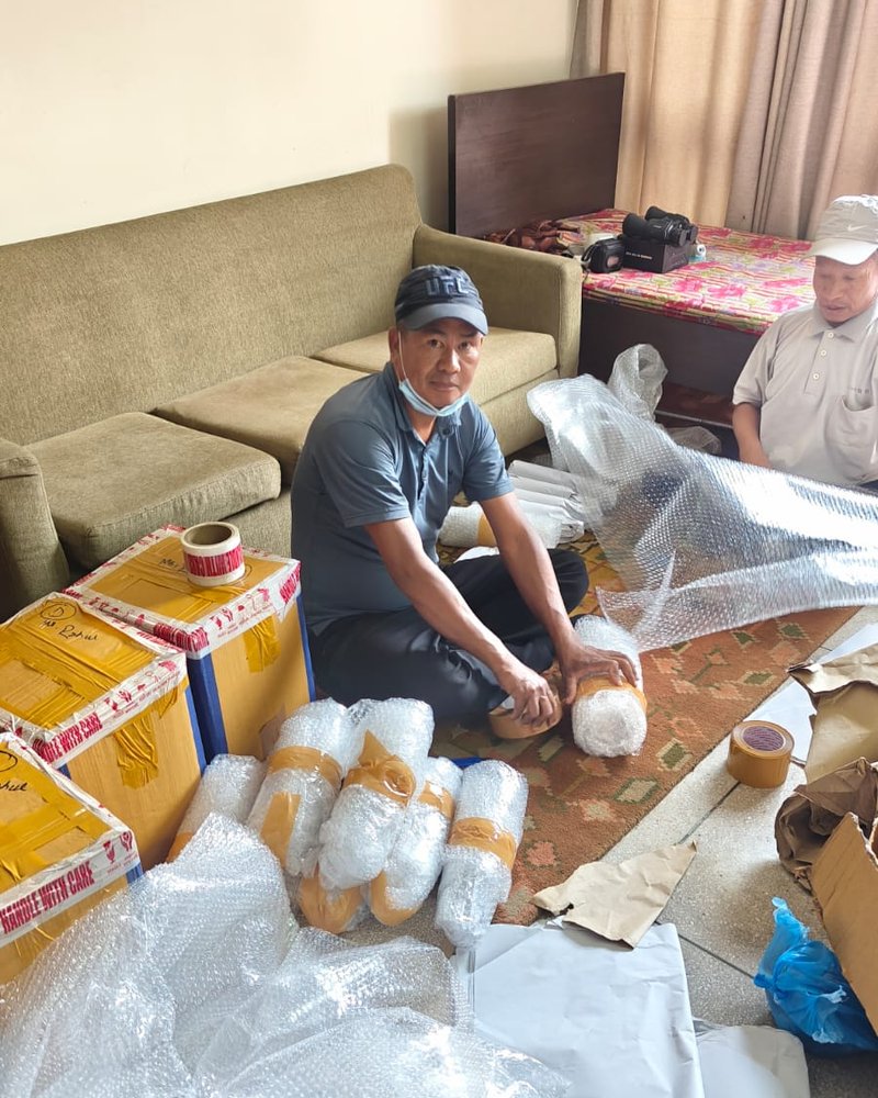 Packer wrapping and taping items during an office relocation