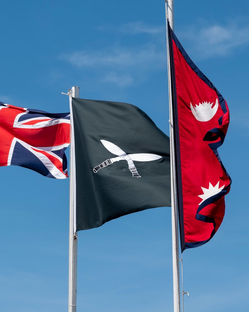 Nepali and partner national flags flying outside a diplomatic mission