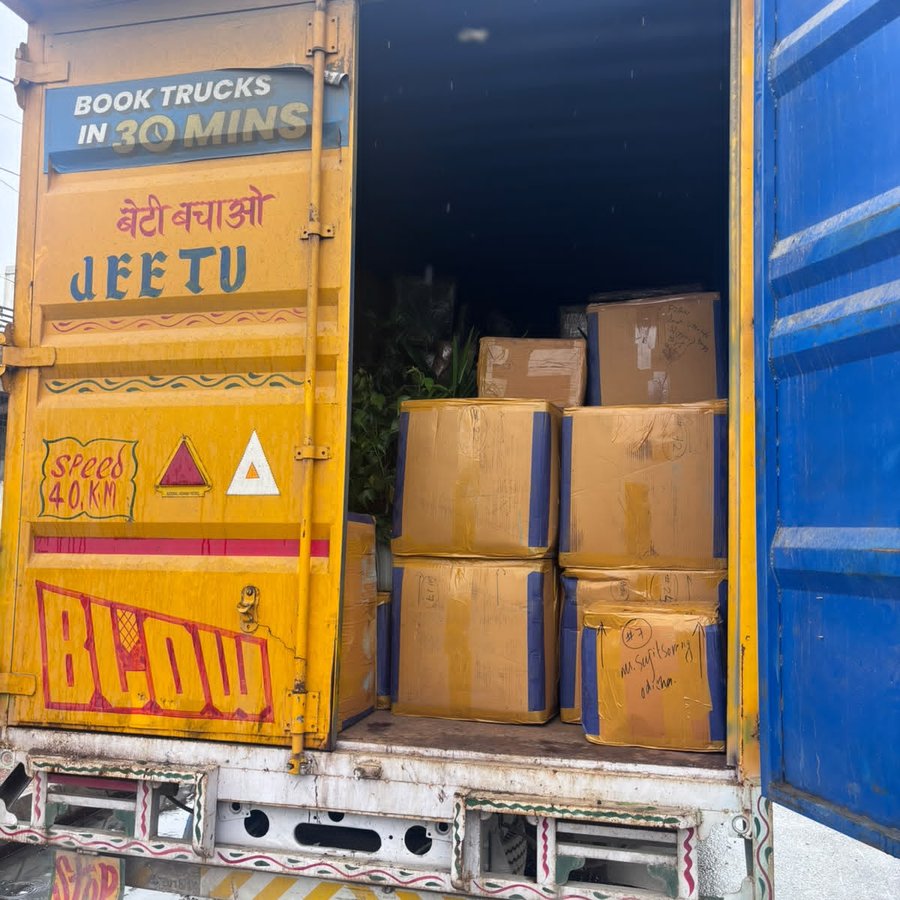 Wrapped and labelled household cartons loaded into a covered truck