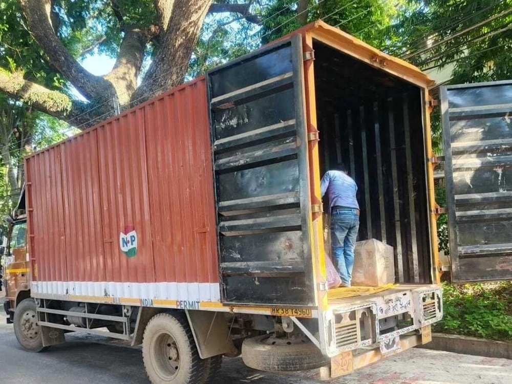 Wrapped consignment being loaded into a covered truck