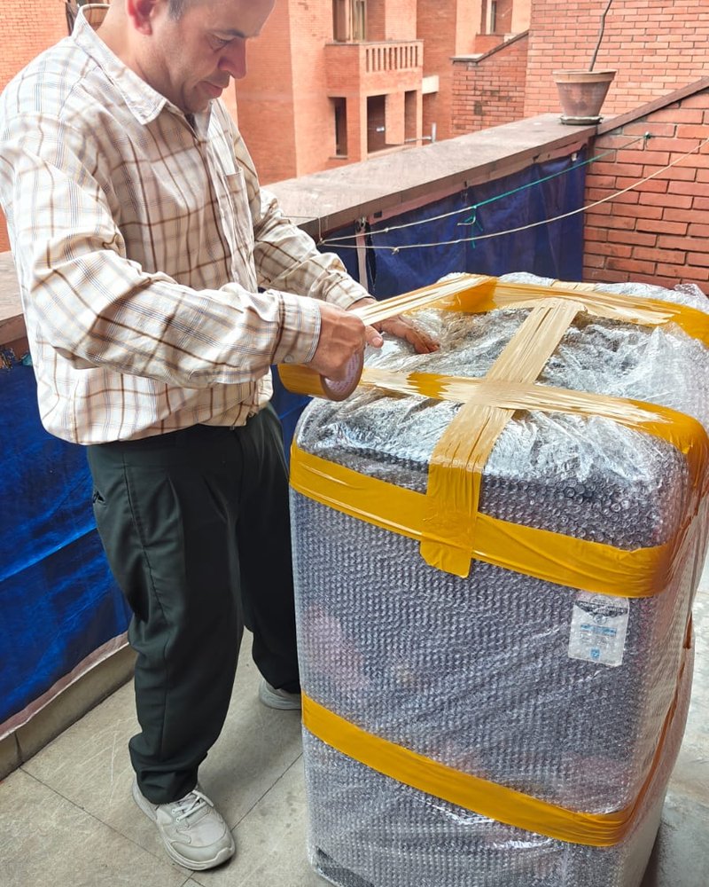 Bubble-wrapping and strapping a household item on site